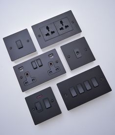 four different types of electrical outlets on a white surface