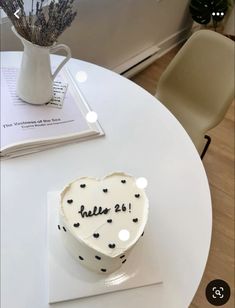 a heart shaped cake sitting on top of a white table