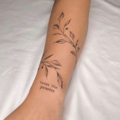 a woman's foot with a tattoo saying trust the process on her left leg