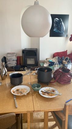 two plates of food sit on a table in front of a lamp and other items