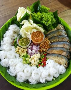 a green plate topped with lots of different foods