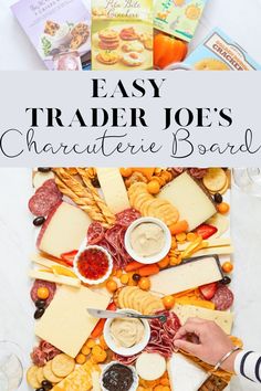 a platter with cheese, crackers and meats on it that says easy trader joe's charcuterie board