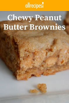 two pieces of chewy peanut butter brownies sitting on top of a white plate