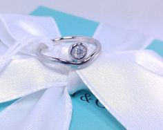 Tiffany & Co. Elsa Peretti Platinum Diamond Curved Band Ring .15 PT 950 Size 6.5 NEW   Tiffany & Co. Elsa Peretti  Platinum Diamond  Curved  Band  Ring .15  PT  950   Size  6 Description Tiffany & Co. Elsa Peretti Platinum Diamond Curved Band Ring .15 PT 950 Size 6   Comes brand new in box with: Tiffany & Co. Elsa Peretti Platinum Diamond Curved Band Ring, pouch, box, note card, envelope, and satin ribbon! Size: 6  Item has been discontinued and is no longer being sold in stores. This is a rare find! Guaranteed to be 100% authentic Tiffany & Co. or your money back.   We only sell authentic merchandise.   Pictures are of actual items you will receive. Please check markings for authenticity. Payment We accept PayPal and all major credit cards. Shipping Shipping and handling is free anywhere Designer Diamond Ring For Anniversary, Designer White Gold Diamond Ring For Wedding, Designer Hallmarked Diamond Ring As Gift, Designer Brilliant Cut Diamond Ring For Anniversary, Luxury Silver Wedding Ring With Bezel Setting, Designer Hallmarked Diamond Ring, Designer Round Diamond Ring Hallmarked, Luxury White Gold Wedding Ring With Bezel Setting, Designer Round Diamond Ring For Anniversary