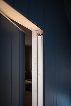 an open door in a room with blue walls and white trim on the outside wall