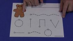 someone is making a paper cutout with a teddy bear