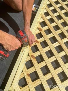 a man using a drill to attach the sides of a wooden bench with nails and screwdrivers