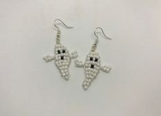 These ghosts are handmade with white & black seed beads. Hypoallergenic stainless steel earring hooks. Ghosts are about 1.5" long. Flexible wires will bend if crushed. Bending them back gently with your fingers should do the trick! Handmade White Earrings For Halloween, Hypoallergenic Adjustable White Beaded Earrings, White Hypoallergenic Beaded Earrings As Gift, Hypoallergenic White Beaded Earrings Gift, Hypoallergenic White Beaded Earrings For Gifts, White Beaded Wire Wrapped Drop Earrings, White Wire Wrapped Dangle Beaded Earrings, White Wire Wrapped Beaded Drop Earrings, Handmade Novelty White Earrings