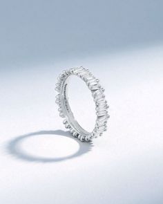 a white gold ring with small diamonds on it