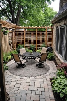 Cozy patio with a round table and four chairs, surrounded by a lattice fence, greenery, and pavers. Patio Upgrade, European Cafe, Budget Patio, Apartment Patio, Vintage Bar Carts, Backyard Remodel, Front Patio, Beautiful Patios, Deck Decorating