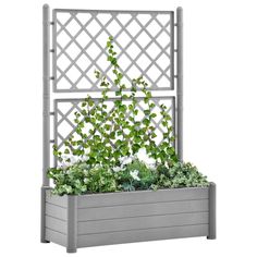 an outdoor planter with plants growing in it