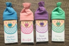 three baby shower products are in the shape of babies's heads and hats on top of each other