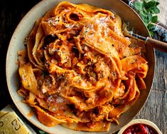 a plate of pasta with meat and sauce