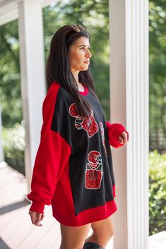 Black and red colorblock sweatshirt with red sequin football uniforms The most fab way to show off your Football Love! Black and red colorblock french terry knit sweatshirt, featuring red sequin football uniforms across the front. Too perfect!! This babe is stylish and comfy, making her a must-have all football season long! Loose relaxed fit Model is 5'3" & sized up to a large for a "dress" look. However, your normal size will still be a loose relaxed fit, just not quite as long! Ribbed crew nec