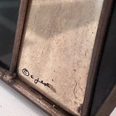 an old window with some writing on it