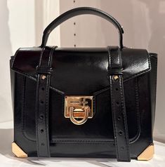 Designer style with just the right amount of edge. Michael Kors' School Crossbody does it right with supple leather, sleek studs and statement Gold-tone hardware MD sized bag 10" TOP, 7.5 Bottom "W x 7.5"H x 4"D (width is measured across the bottom of handbag); t Silhouette is based off 5'9" model 5" handle and 19-21"L detachable strap Flip-lock closure Gold-tone exterior hardware & 1 front slip pocket 1 zip pocket and 1 open pocket Style: 35H5GNCS6M Retail price; $598  SHIPPING : We ship out within 1-2 business day once the payment is cleared through PAYPAL. Shipping within USA, Signature Confirmation is Required Upon Delivery for item that is over $250. INTERNATIONAL SHIPPING IS COST VARIES BY BUYER LOCATION AND COUNTRY. WE SHIP TO WORLDWIDE by UPS FEDEX, USPS PRIORITY AND EXPRESS mail t Luxury Satchel Bag With Hardware, Michael Kors Crossbody Satchel With Gold-tone Hardware, Designer Rectangular Bag With Hardware, Evening Satchel Bag With Hardware Details, Evening Satchel Bag With Hardware, Trendy Leather Bags With Hardware, Michael Kors Top Handle Shoulder Bag With Metal Hardware, Evening Bags With Metal Hardware In Faux Leather, Shopping Satchel With Metal Hardware And Crossbody Shape