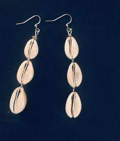 Beautiful Diva cowrie she'll hook dangle earrings. These earrings are the perfect accent to an upscale or dress down outfit. Accentuate you outfit with acuity real piece. Cowrie shells were used in ancient times as currency for trade. Casual Summer Dangle Jewelry, Trendy Beach Drop Earrings, Elegant Shell Jewelry For Beach Season, Casual Summer Shell-shaped Jewelry, Elegant Earrings With Ear Wire For Vacation, Casual Drop Earrings For Vacation, Casual Beach Season Earrings For Vacation, Casual Silver Earrings For Summer, Silver Casual Summer Earrings