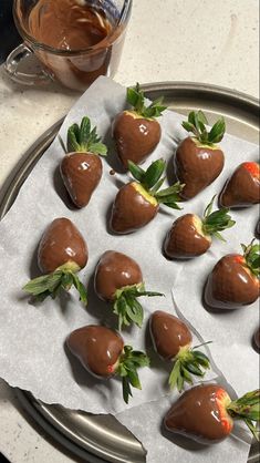 chocolate covered strawberries are arranged on a plate