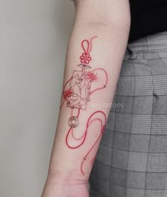 a woman with a red tattoo on her arm