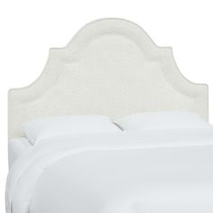 an upholstered headboard with white linens and buttons on the top part