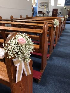 a bouquet of flowers sitting on the pews of a church