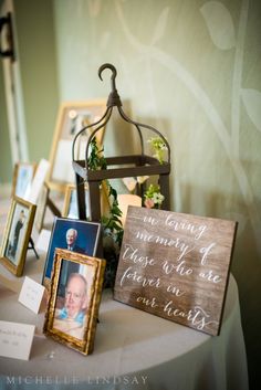 a table topped with pictures and framed photos