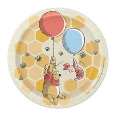 a paper plate with winnie the pooh and piglet on it, holding balloons