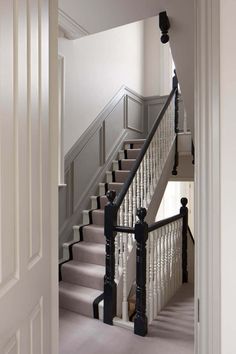 an image of stairs and railings in a house or office area with white walls