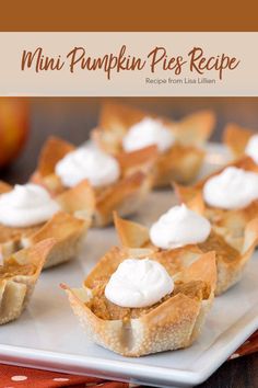 mini pumpkin pies on a white plate with whipped cream in the middle and an apple behind