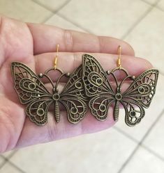 New  Handmade  Large Butterfly Earrings  These bohemian beauties are sure to make your heart flutter!   ♡ Chose from Bronze butterflies with 14k Gold over silver ear hooks (or) Stainless steel butterflies with .925 Sterling Silver ear hooks ♡ Stunning filigree detailed butterfly charms measure 1.5 inches tall x 1.5 inches wide ♡ Dangle length with hook measures 1.75 inches  ♡ Hypoallergenic, nickel free  Ships within 24 hours of cleared payment Monday-Saturday Gift Packaging & Messages: Your ite Handmade Butterfly Metal Earrings, Handmade Metal Butterfly Earrings, Bohemian Butterfly Jewelry With Pierced Design, Bohemian Gold Butterfly Jewelry, Gold Butterfly Jewelry For Festival, Butterfly Earrings For Jewelry Making, Bohemian Nickel-free Heart Earrings For Festival, Bohemian Nickel-free Heart Earrings, Bohemian Butterfly Earrings For Pierced Ears