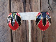 "80s or perhaps 90s red and black enamel on gold tone setting clip on earrings. One earring weighs 11.2 grams which is about the equivalent of two quarters (coins).  Not too heavy.  They are 1-3/8\" x 1\" Good vintage condition with minimal signs of use and age. No real defects but for a little tarnish on underside." Red Enamel Earrings For Party, Red Enamel Clip-on Earrings, 90s Earrings, Black Enamel, Statement Earrings, Clip On Earrings, Color Block, Cuff Bracelets, Gold Earrings