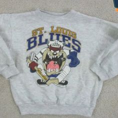 Vintage Nhl St. Louis Blues Looney Tunes Taz T-Shirt, St. Louis Blues Shirt, Ice Hockey Shirt, Unisex Shirt, Vintage Shirt Nererfr Reprinted Shirt Made By Gildan Brand 5.3-Ounce, 100% Cotton (99/1 Cotton/Poly (Ash) & 90/10 Cotton/Poly (Sport Grey) Heavyweight Classic Unisex Tee Taped Neck And Shoulders; Tearaway Label Decoration Type: Digital Print Hockey Shirts, St Louis Blues, Looney Tunes, Blue Shirt, Vintage Shirts, Unisex Shirt, Nhl, Mens Shirts, Man Shop