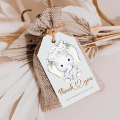 an elephant with flowers on it's head is attached to a tag that says thank you