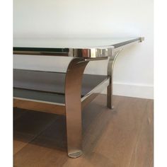 a metal table sitting on top of a hard wood floor