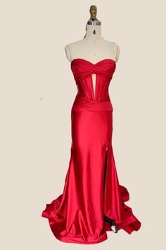 a red dress on a mannequin dummy with the back cut out to show it's cleavage