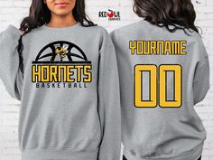 Personalized Hornet School Spirit T-Shirt Crewneck, Hoodie Hooded Sweatshirt Football, Baseball, Basketball, Softball, Track, Volleyball, Cross Country, Cheer, Wrestling Not all colors are available in all sizes and styles.  Please check the color and size charts in photos. We do our best to accurately represent shirt colors by using actual photos but do understand that all monitors will display differently. Please contact us prior to purchase with any questions on sizing or colors. Your purchase includes a custom imprint created specifically for your team! A product proof will be emailed to you within 1 business day.  Please keep an eye on your Etsy messages and reply with any changes within 24 hours. Your order will be sent to production after that time if no response is received. Excess Eagles Basketball Shirt, Basketball Hoodies, Hornets Basketball, Represent Shirt, Basketball Cheers, Basketball Sweatshirts, Cricket Ideas, Cheer Shirts, Basketball T Shirt