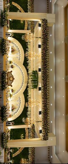 an overhead view of a wedding venue with flowers and greenery in the center, surrounded by lights