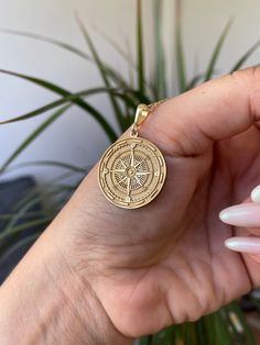 Introducing the Compass Pendant Necklace, a striking piece of jewelry crafted from high-quality 925 sterling silver and 14K solid gold. This handmade necklace features a detailed pendant adorned with a compass design, symbolizing guidance, adventure, and exploration. Perfect for those who appreciate meaningful and symbolic accessories, this necklace is available in customizable chain lengths of 16, 18, 20, and 22 inches. -Material: 14K Solid Gold / 925 Sterling Silver -Pendant Size: Customizable 14k Gold Medallion Amulet Jewelry, Spiritual 14k Gold Jewelry Stamped 14k, Spiritual 14k Gold Medallion Jewelry, Handmade 14k Gold Round Pendant Jewelry, Tarnish Resistant Brass Medallion Jewelry, Engraved White Gold Round Jewelry, 14k Gold Tarnish Resistant Amulet Jewelry, Symbolic White Gold Jewelry With Coin Pendant, 14k Gold Tarnish-resistant Amulet Jewelry