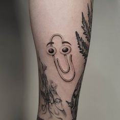 a man's leg with a tattoo on it and an eyeball in the shape of a letter