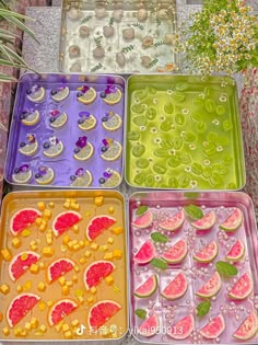 four trays filled with different types of fruit