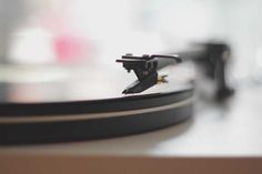 a record player's turntable is shown in this close up photo with blurry background