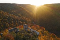 the sun shines brightly over an old ruin in autumn