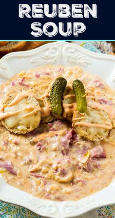 a white bowl filled with soup and topped with cucumbers