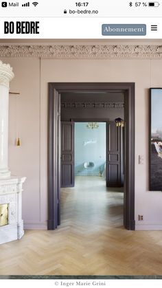 an open door leading to another room with paintings on the wall