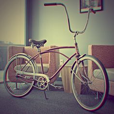 a bike is parked in front of a couch