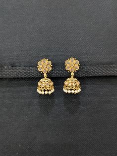 Earring length: 1.45 inches; Earring width: 0.7 inches. Earrings weight: 12 grams / 0.4 oz (both earrings together). Please allow some slight variation in color. Gold plated small jhumka. Pearl bead / Gold bead dangle Jhumka earrings. Shiny honey yellow polki stone pasted jhumka earrings. Base material is made of copper alloy. Bohemian Cheap Jhumkas For Diwali, Affordable Elegant Chandbalis For Diwali, Cheap Traditional Round Jhumkas, Elegant 22k Gold Luxury Chandbalis, Luxury Gold Plated Chandbalis For Celebration, Luxury Heavy Gold Chandbalis, Small Gold Jhumka, Small Jhumki Earrings Gold, Small Gold Earrings Indian