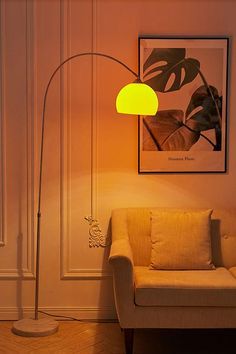 a living room scene with focus on the floor lamp and chair in front of the couch