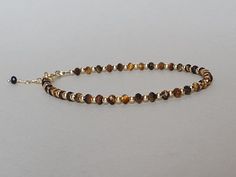 Such a lovely bracelet with genuine tiger's eye rondelles Please measure tightly your wrist's circumference, using a ribbon or something similar, and then measuring the ribbon with a ruler. When ordering, please select the actual wrist size, not the size of the bracelet. I will make the bracelet fit your wrist, by adding approx 0.6 inch to the circumference. The bracelet was set up using genuine tiger's eye faceted rondelles and gold filled findings and it is adjustable. Available also with sterling silver findings. A stone of protection, Tiger Eye may also bring good luck to the wearer.  It has the power to focus the mind, promoting mental clarity, assisting us to resolve problems objectively and unclouded by emotions.  Particularly useful for healing psychosomatic illnesses, dispelling f Brown Faceted Beads Bracelets As Gift, Brown Bracelets With Faceted Beads As Gift, Elegant Brown Beaded Bracelets As Gift, Brown Bracelets With Faceted Beads For Gift, Brown Faceted Beads Bracelet For Gift, Tiger Eye Bracelet For Women, Tigers Eye Beaded Bracelet, Tigers Eye Crystal Bracelet, Tiger Eye Gemstone