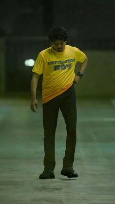 a man in a yellow shirt is skateboarding