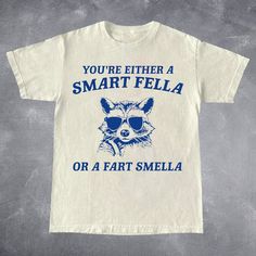 Are You A Smart Fella Or Fart Smella? Retro Cartoon T Shirt, Weird T Shirt, Meme T Shirt, Trash Panda T Shirt, Unisex | HOW TO ORDER | 1. Review the photos. 2. Pick your t-shirt size and color. 3. Click "Add to Cart." You can return to add more products. 4. Click "Proceed to Checkout." THE FIT - Comfortable unisex fit - 100% cotton - Professional high quality print - For baggy fit go one size up ORDER & SHIPPING INFO - Your order will be ready in 1-5 business days, and we often deliver sooner th Cheap Funny Shirt With Character Print, Cheap Funny Cartoon Print T-shirt, Cheap Funny Tops With Cartoon Print, Panda T Shirt, Panda Tshirt, Retro Cartoon, Cartoon T Shirt, Trash Panda, Meme Tshirts